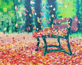 Falling colorful leaves on a bench